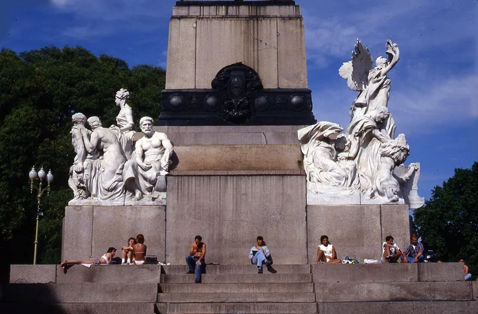Sculptural monument with people sitting on its steps